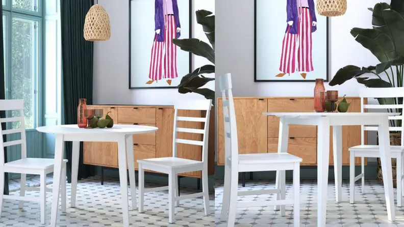 Small white table with two chairs in living room.
