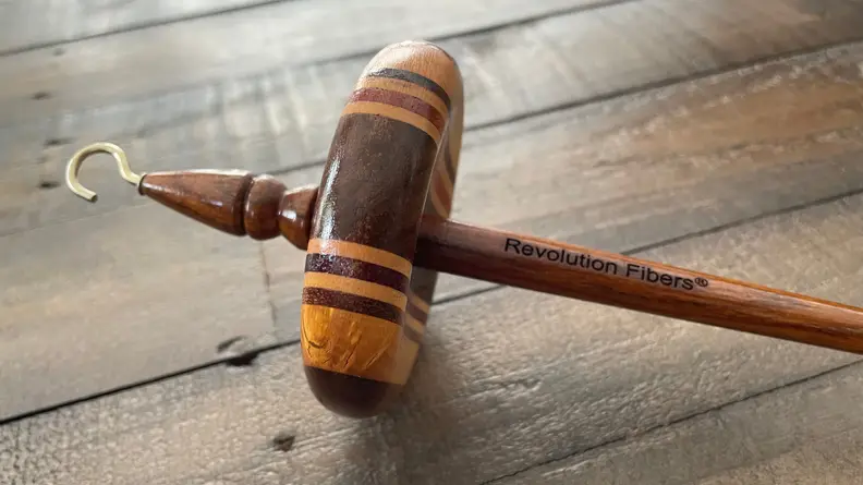 Wooden drop spindle on a table