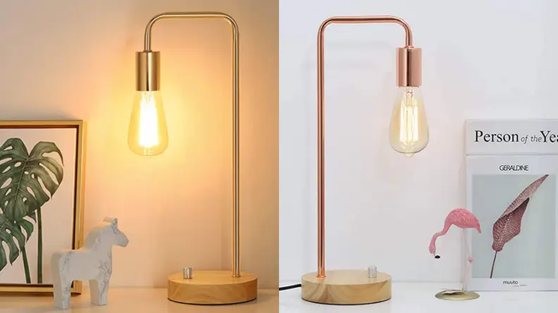 A metal lamp with a long lightbulb.