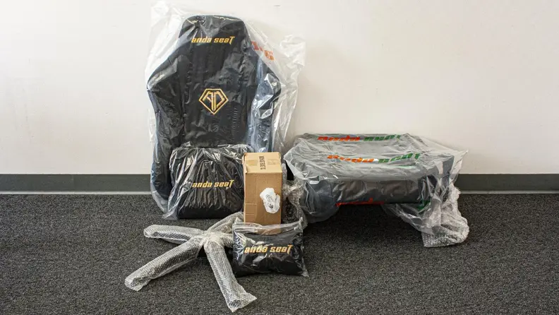 Individual pieces of the AndaSeat Phantom 3 gaming chair in bubble wrap.