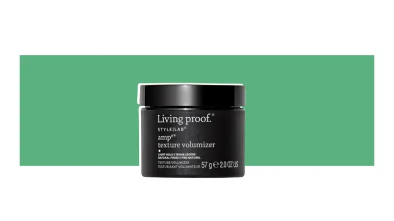 Living Proof. hair product on a green background.