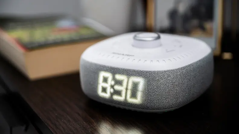 the sharp alarm on a bedside table with a work