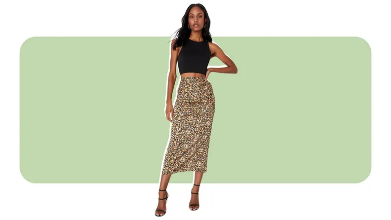 A model wearing a floral print midi skirt.
