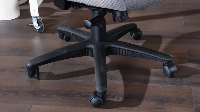 Close-up shot of the adjustable setting and chair legs with wheels.