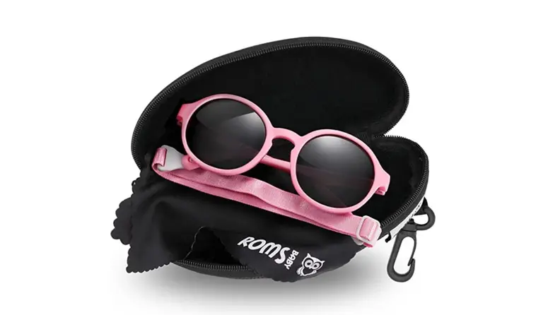 A pair of pink sunglasses on a black case.