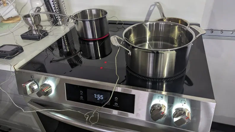 Two pots on top of the Frigidaire Gallery stove, being tested.