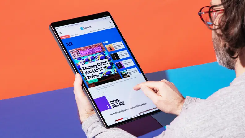 A person holding the tablet vertically.