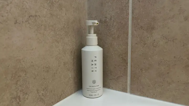 Photo of the Fenty Hair The Rich One Moisture Repair Shampoo in a shower.