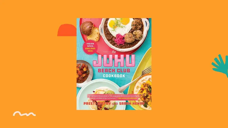 Juhu Beach Club cookbook against a bright orange background.