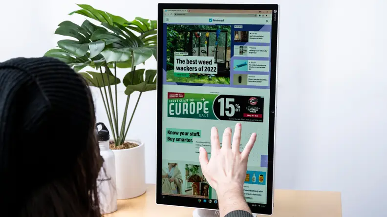 A person touching a computer's display