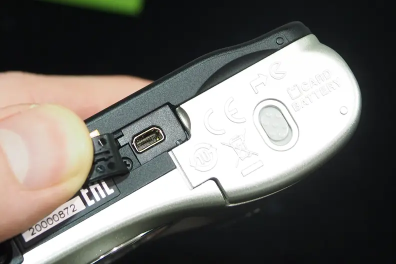 On the underside of the Nikon Coolpix L32 is the USB port, as well as the battery compartment.