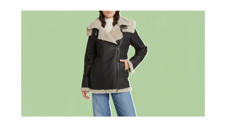 A model wearing a brown shearling coat.