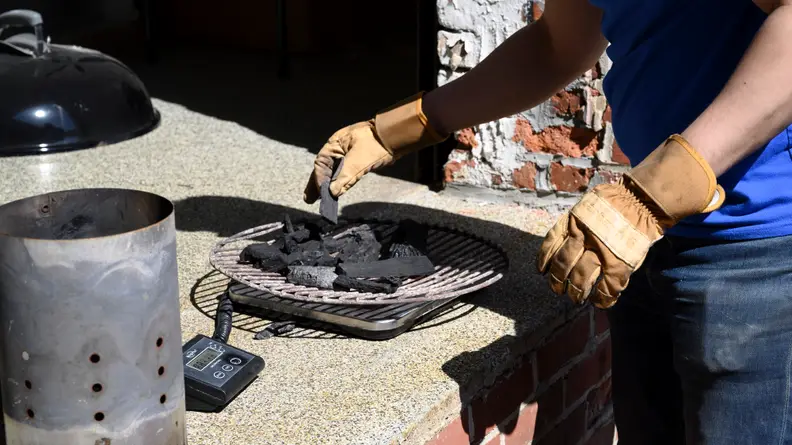 A person weighing charcoal