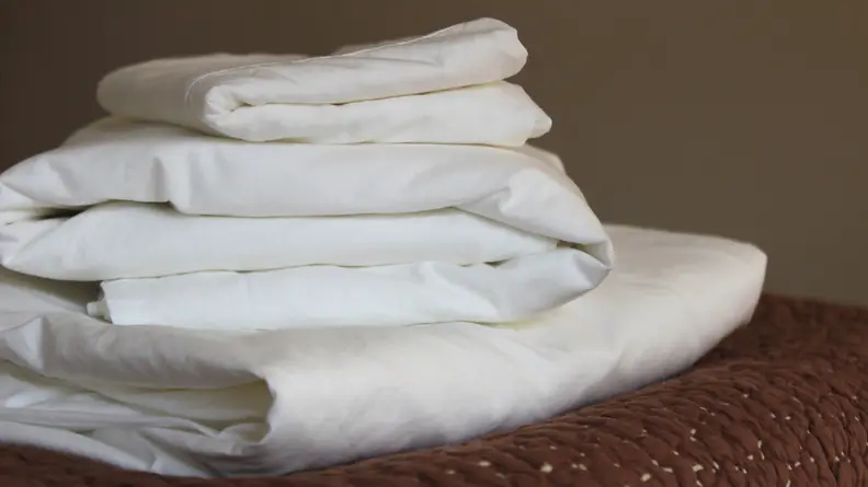 A stack of folded Boll & Branch percale sheets.