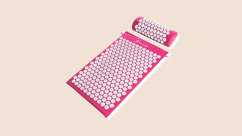 A pink ProsourceFit Acumat with white pressure points on a neutral background.