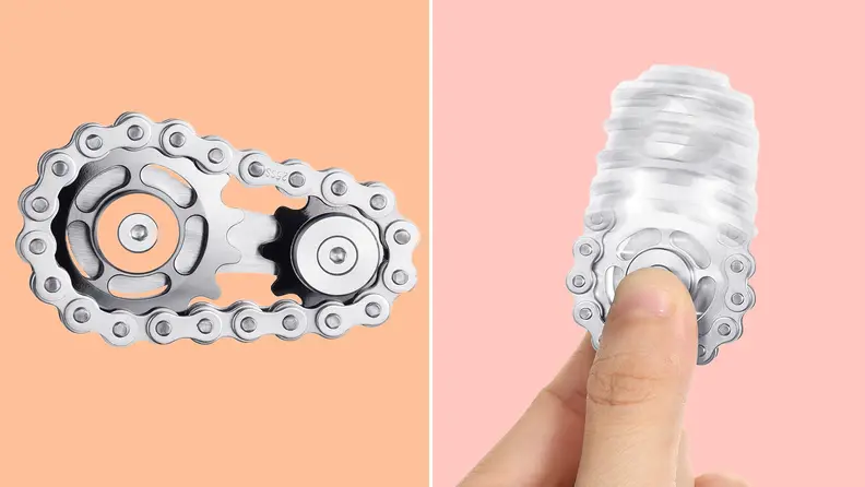 Person holding silver gear-shaped fidget spinner.