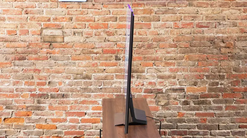 A side view of the LG G3 OLED TV against a brick wall.