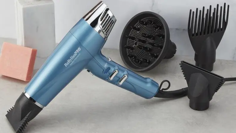 BaBylissPro Nano Titanium hair dryer sits on counter with included attachments