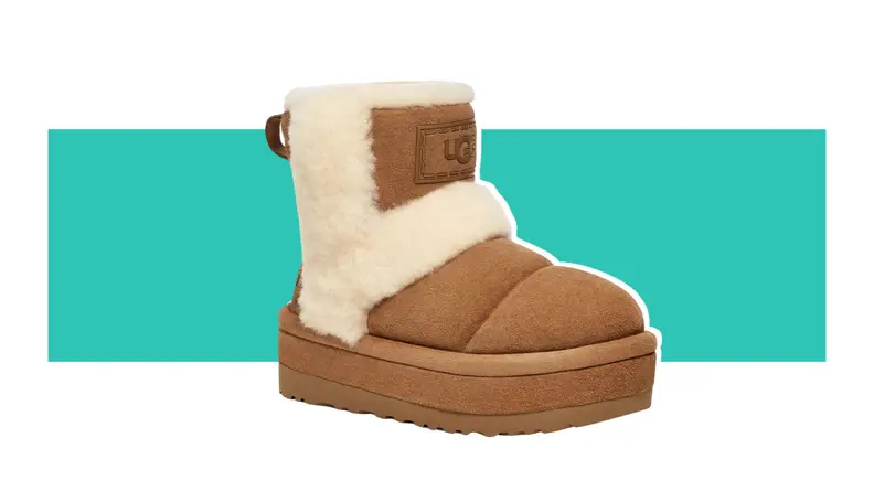 A brown Ugg boot with shearling detailing on the sides.