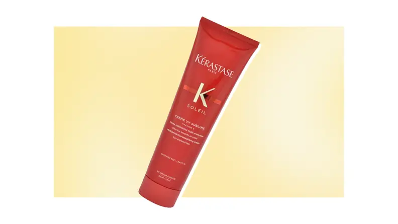 A red tube of sun damage hair protection against a yellow background.