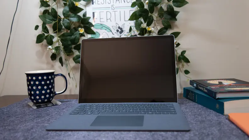 The laptop is open on a desktop.