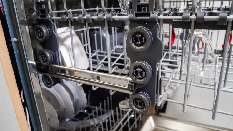 A shot of the side of the GE GDP645SYN0FS dishwasher's upper rack, highlighting the mechanism for raising and lowering the rack.