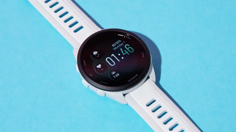 A close-up of the Garmin Forerunner 165 watch on a blue background.
