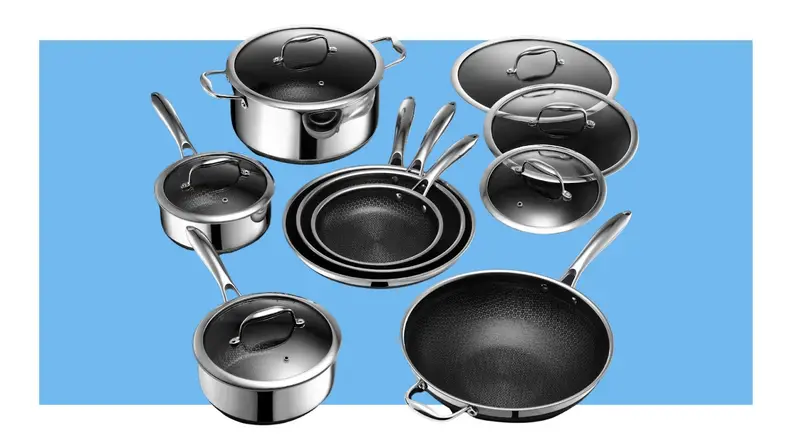 Stainless steel Hexclad Hybrid cookware set with lids in front of blue background.