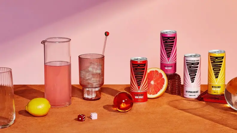 Several cans of Ramona organic Sicillian wine next to glasses with ice in them.