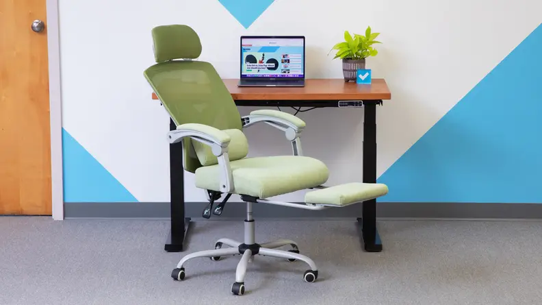 Green Edx Reclining Office Chair in front of desk with laptop computer.