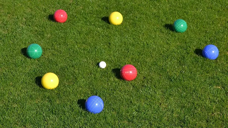 Close up of colorful boccee balls on a lawn.