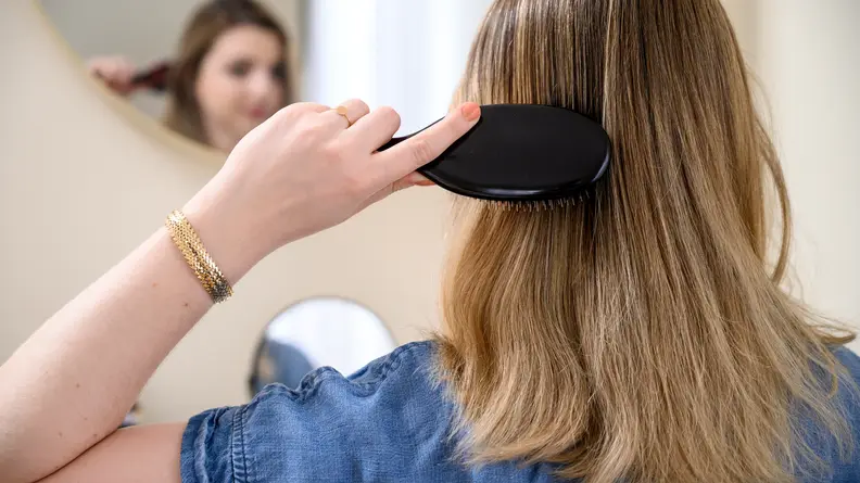 A photo of the author using the Mason Pearson hair brush.