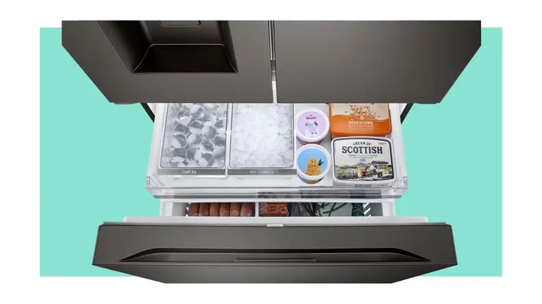 Cubed ice and crushed ice storage separately next to assorted frozen foods inside of the black stainless steel LG LRYXC2606D French-Door Smart Refrigerator.