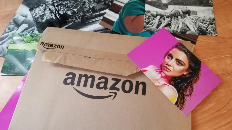 Amazon logo on a brown envelope with a photo of a woman on top.
