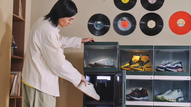 A person storing their shoes in LG Styler ShoeCase.