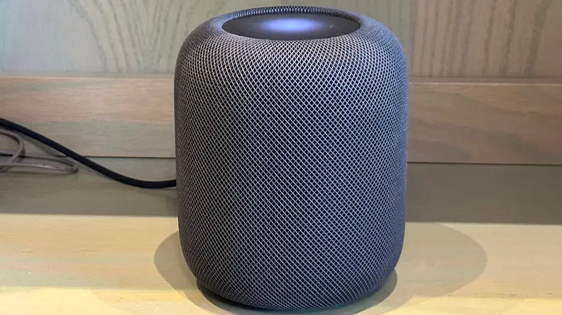 A second-gen Apple HomePod sits on a desk