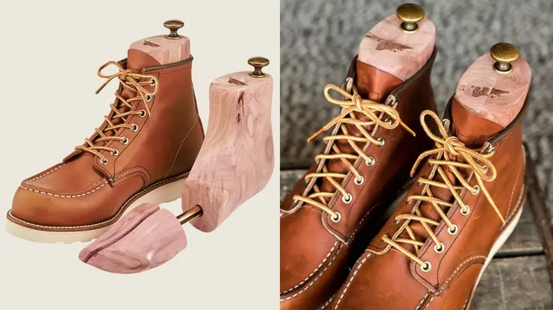 pair of red wing boots with cedarwood shoe trees inside of them
