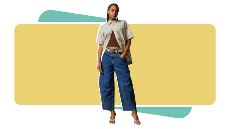 A model wearing dark blue jeans with a plaid shirt.