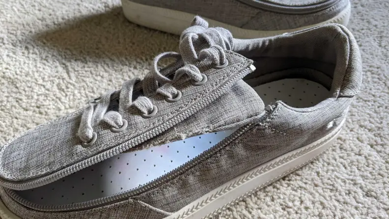 A sneaker by Billy Footwear with an open zipper.