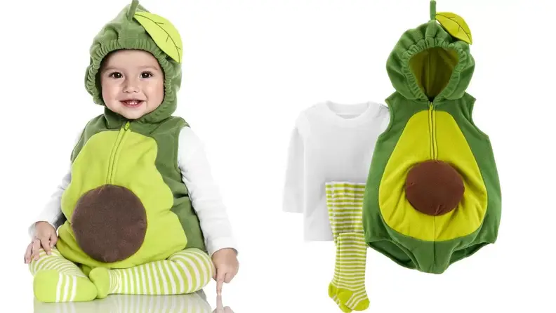 A baby dressed in an avocado costume.