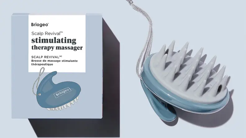 On the left: A gray Briogeo box. On the right: A gray, spiky scalp massager.