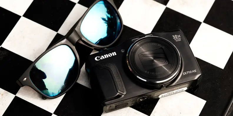 A photo of the Canon PowerShot SX710 HS on a checkerboard