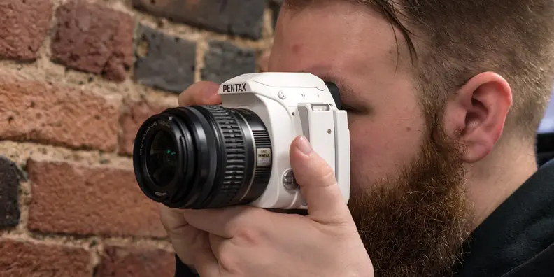A photograph of the Pentax K-S1 in use.