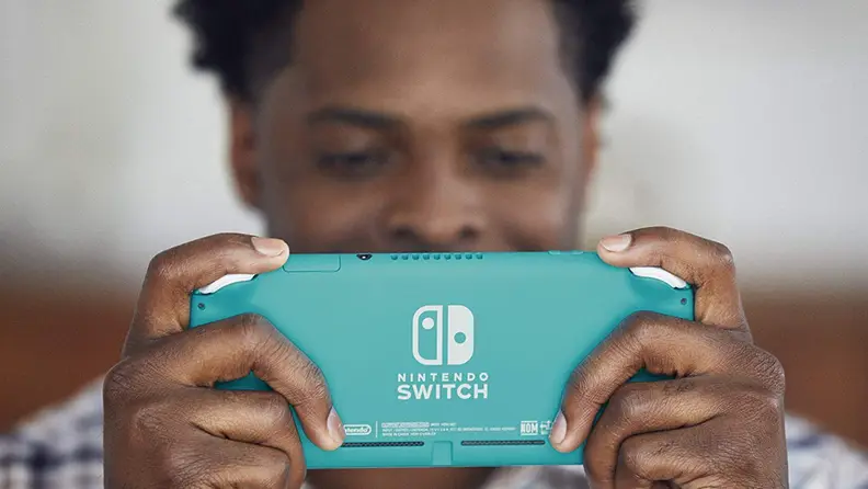 A person plays with a handheld Nintendo Switch