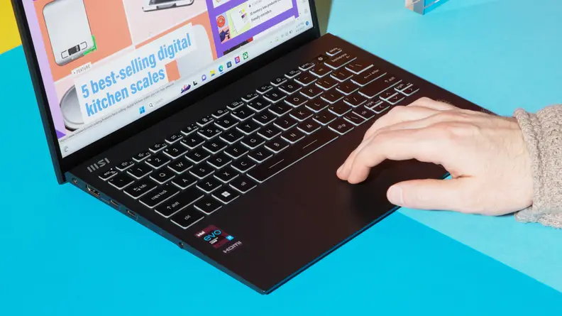 A hand touching the trackpad.