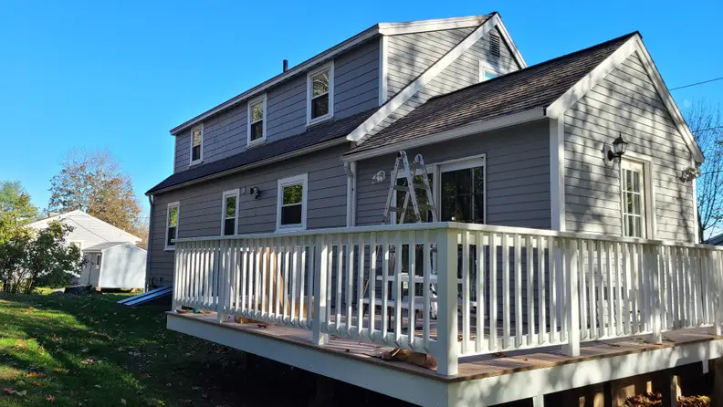 A ladder beside a gray house