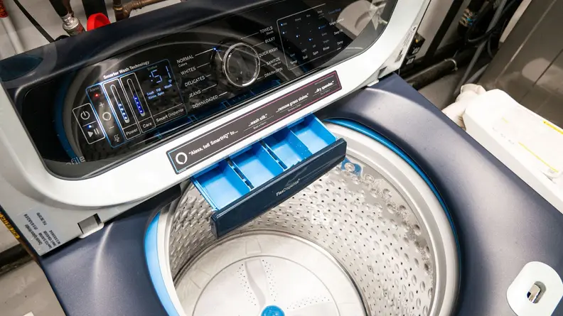 Product shot of the detergent dispenser inside of the GE Profile PTW900BPTRS washing machine.