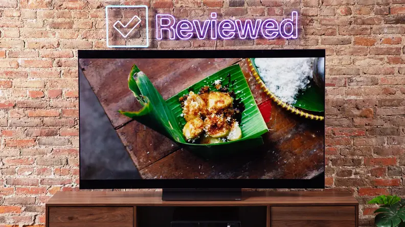 Front photo of the LG C3 OLED TV with a meal onscreen.