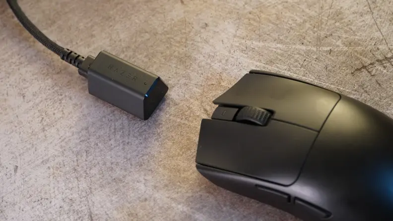 A black Razer Viper V3 Pro mouse, with a USB-C hyperpolling dongle