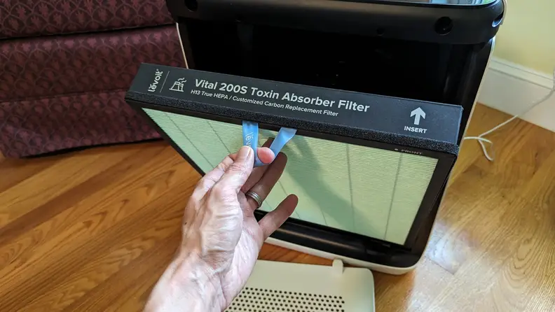 A hand holding a filter.